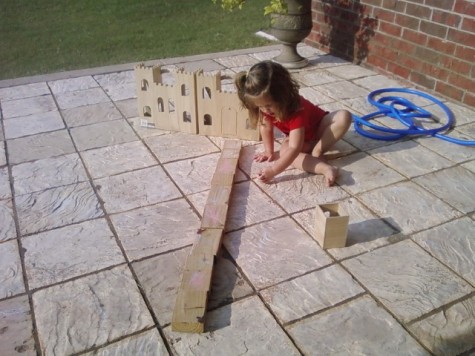 Ingrid building road to castle with blocks in back yard