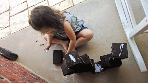 Ingrid drawing chalk on her chalk blocks